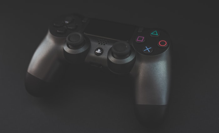 Black PS4 Controller on black background