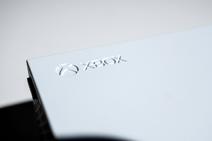 Close up of Xbox console logo on white surface