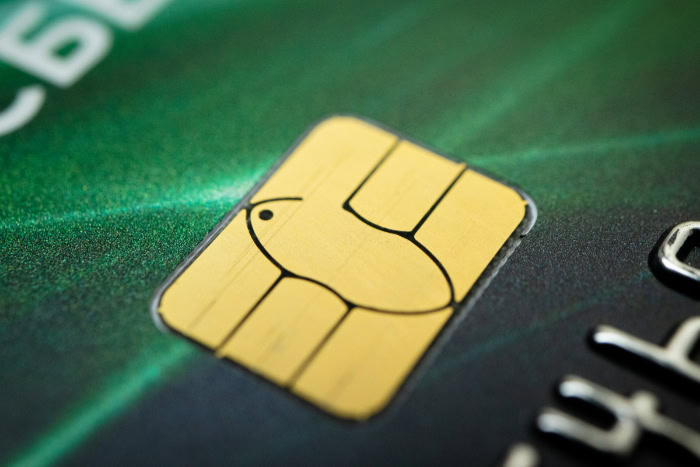 Close up of a credit card chip on green card