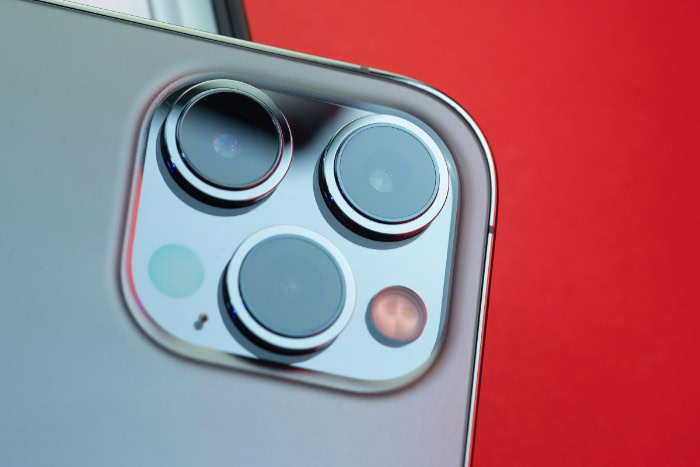 Close up of iPhone camera lenses on red background