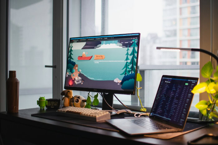 Home office workspace with monitor and laptop setup