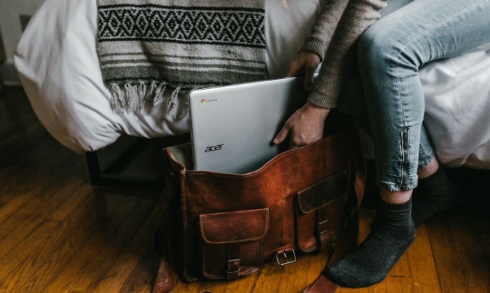 Person holding Chromebook