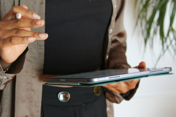 Person holding iPad with stylus and case
