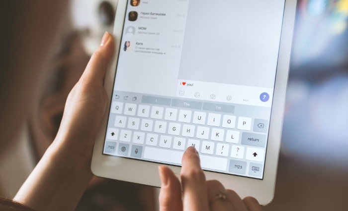 Person typing on iPad