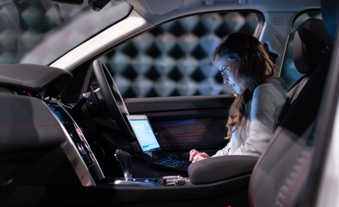 Person using laptop in a car