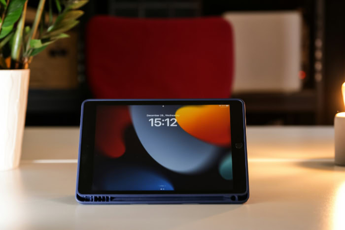 iPad in blue case on desk with screen on