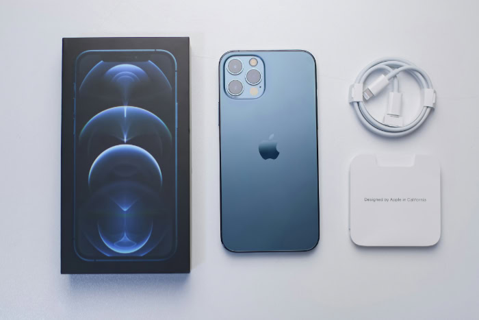 iPhone accessories and box arranged on table